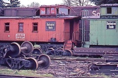 Photo of a Railroad Wrecking Yard in the middle of the forest in Oregon.  This is from a 35mm slide and taken over 40 years ago.