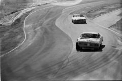 Photo of Richard Petty coming into Turn 6 at a NASCAR Race at Riverside.  His car is duct taped together.