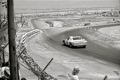 Photo of Bobby Allison exiting Turn 6 at a NASCAR Race at Riverside.