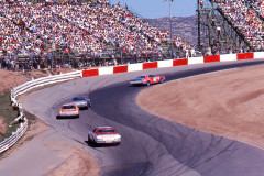 Photo of a NASCAR race at Riverside, CA.  The grandstands and turn 6.