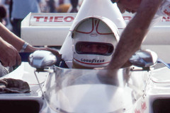 Photo of Alan Jones on the starting grid at Riverside.  1975