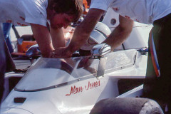 Photo of Alan Jones on the starting grid at Riverside.  1975