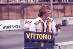 Photo of crewman with signboard for Vittorio Brambilla. 1977 F1 LBGP