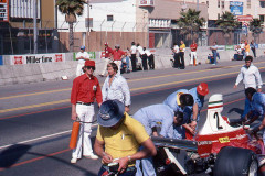 Photo of Parnelli Jones and Al Unser in the pit lane..  3 Kilo is in the red shirt holding the fire extinguisher.  1976