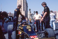 Photo of F1 Lotus in the pit lane,  Colin Chapman is at the rear wearing a hat.  1976