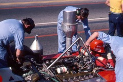 Photo of Niki Lauda in his F1 Ferrari in the pit lane.  1976